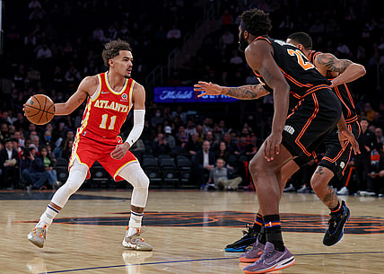 Mar 22, 2022; New York, New York, USA; Atlanta Hawks guard Trae Young (11) dribbles against New York Knicks center Mitchell Robinson (23) and forward Obi Toppin (1) during the first quarter at Madison Square Garden. Mandatory Credit: Vincent Carchietta-USA TODAY Sports
