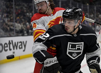 Dec 22, 2022; Los Angeles, California, USA; Calgary Flames defenseman Rasmus Andersson (4) and Los Angeles Kings left wing Kevin Fiala (22) go for the puck in the second period at Crypto.com Arena. Mandatory Credit: Jayne Kamin-Oncea-USA TODAY Sports
