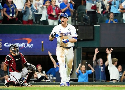 Oct 27, 2023; Arlington, Texas, USA; Texas Rangers Corey Seager (5) hits a two-run home run off Arizona Diamondbacks relief pitcher Paul Sewald (38) in the ninth inning during Game 1 of 2023 World Series at Globe Life Field. Mandatory Credit: Rob Schumacher-Arizona Republic