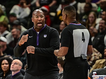 Dec 7, 2022; Milwaukee, Wisconsin, USA;  Sacramento Kings head coach Mike Brown talks to referee Sean Wright in the third quarter at Fiserv Forum. Mandatory Credit: Benny Sieu-USA TODAY Sports