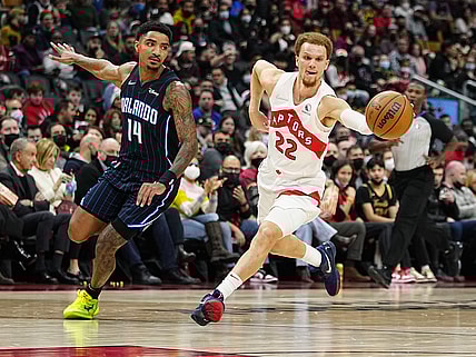 Mar 4, 2022; Toronto, Ontario, CAN; Toronto Raptors guard Malachi Flynn (22) drives to the basket against Orlando Magic guard Gary Harris (14) during the first half at Scotiabank Arena. Mandatory Credit: John E. Sokolowski-USA TODAY Sports