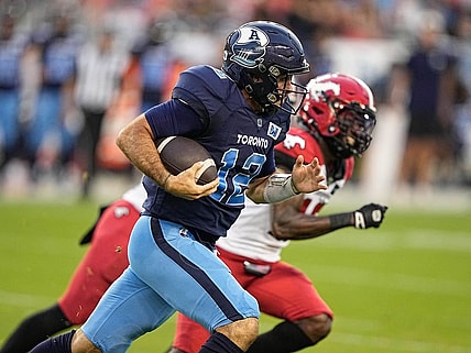Aug 20, 2022; Toronto, Ontario, CAN; Toronto Argonauts quarterback Chad Kelly (12) and Calgary Stampeders defensive back Natrell Jamerson (16) at BMO Field. Mandatory Credit: John E. Sokolowski-USA TODAY Sports