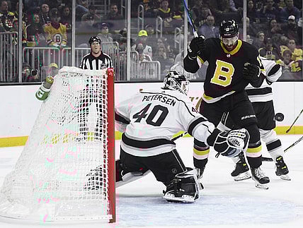 Mar 7, 2022; Boston, Massachusetts, USA;  Boston Bruins left wing Nick Foligno (17) eyes the puck as it goes past Los Angeles Kings goaltender Cal Petersen (40) during the first period at TD Garden. Mandatory Credit: Bob DeChiara-USA TODAY Sports