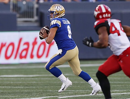 Aug 25, 2022; Winnipeg, Manitoba, CAN;  Winnipeg Blue Bombers quarterback Zach Collaros (8) looks for a receiver during the first half against the Calgary Stampeders at IG Field. Mandatory Credit: Bruce Fedyck-USA TODAY Sports