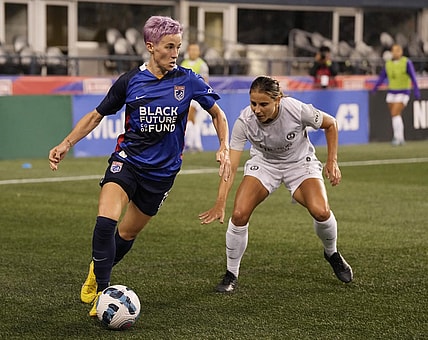 Oct 1, 2022; Seattle, Washington, USA; OL Reign forward Megan Rapinoe (15) controls the ball against Orlando Pride defender Kylie Strom (23)in the first half at Lumen Field. Mandatory Credit: Stephen Brashear-USA TODAY Sports