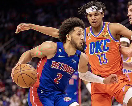 Nov 7, 2022; Detroit, Michigan, USA; Oklahoma City Thunder forward Ousmane Dieng (13) defends against Detroit Pistons guard Cade Cunningham (2) during the second half at Little Caesars Arena. Mandatory Credit: David Reginek-USA TODAY Sports