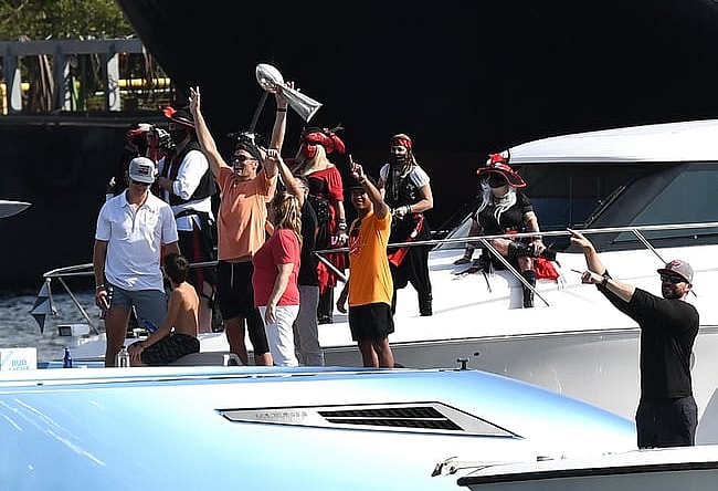 Feb 10, 2021; Tampa Bay, Florida, USA; Tampa Bay Buccaneers quarterback Tom Brady celebrates with the Vince Lombardi Trophy on his boat during the Tampa Bay Buccaneers boat parade to celebrate their victory over the Kansas City Chiefs in Super Bowl LV. Mandatory Credit: Jonathan Dyer-USA TODAY Sports