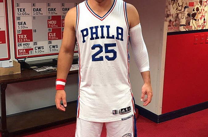 Here is Mike Trout wearing a full Sixers get-up.