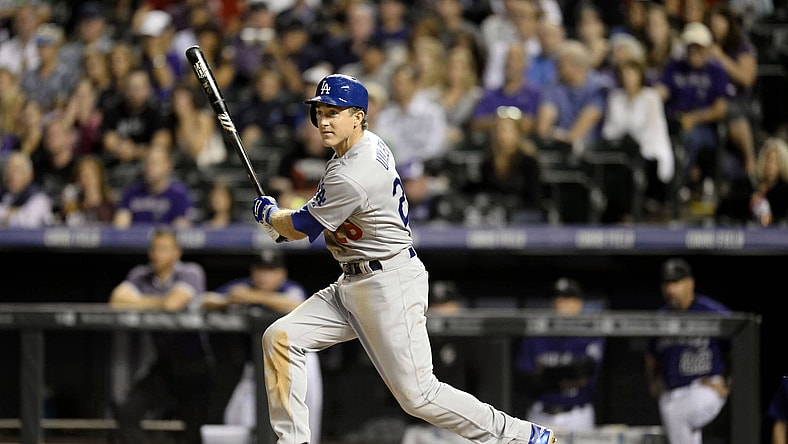 Sep 25, 2015; Denver, CO, USA; Los Angeles Dodgers third baseman Chase Utley (26) doubles in the fifth inning against the Colorado Rockies at Coors Field. Mandatory Credit: Ron Chenoy-USA TODAY Sports