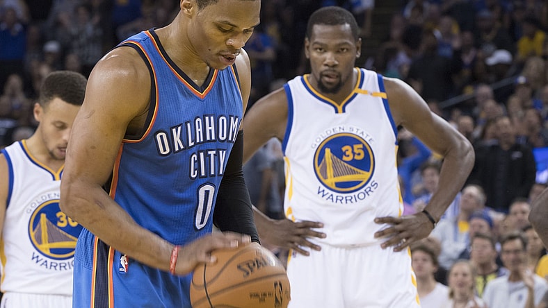 November 3, 2016; Oakland, CA, USA; Oklahoma City Thunder guard Russell Westbrook (0) shoots a technical foul shot as Golden State Warriors forward Kevin Durant (35) looks on during the second quarter at Oracle Arena. Mandatory Credit: Kyle Terada-USA TODAY Sports