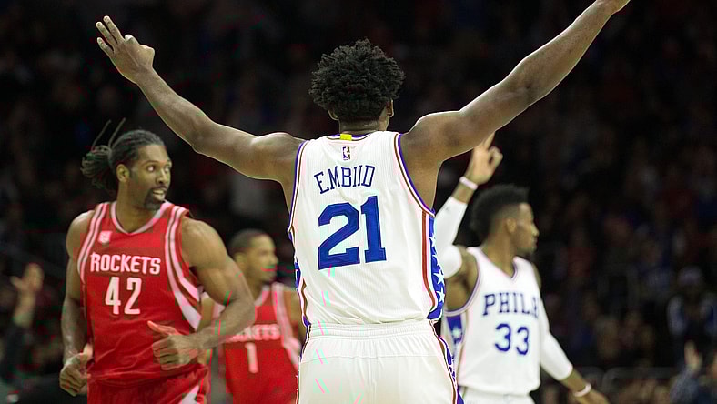 Jan 27, 2017; Philadelphia, PA, USA; Philadelphia 76ers center Joel Embiid (21) reacts to his three pointer in front of Houston Rockets center Nene Hilario (42) during the first quarter at Wells Fargo Center. Mandatory Credit: Bill Streicher-USA TODAY Sports