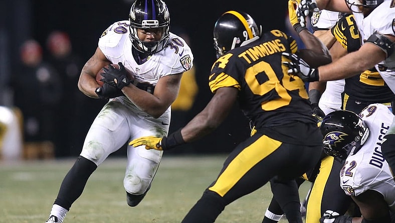 Dec 25, 2016; Pittsburgh, PA, USA; Baltimore Ravens running back Kenneth Dixon (30) rushes the ball against Pittsburgh Steelers inside linebacker Lawrence Timmons (94) during the fourth quarter at Heinz Field. The Steelers won 31-27. Mandatory Credit: Charles LeClaire-USA TODAY Sports