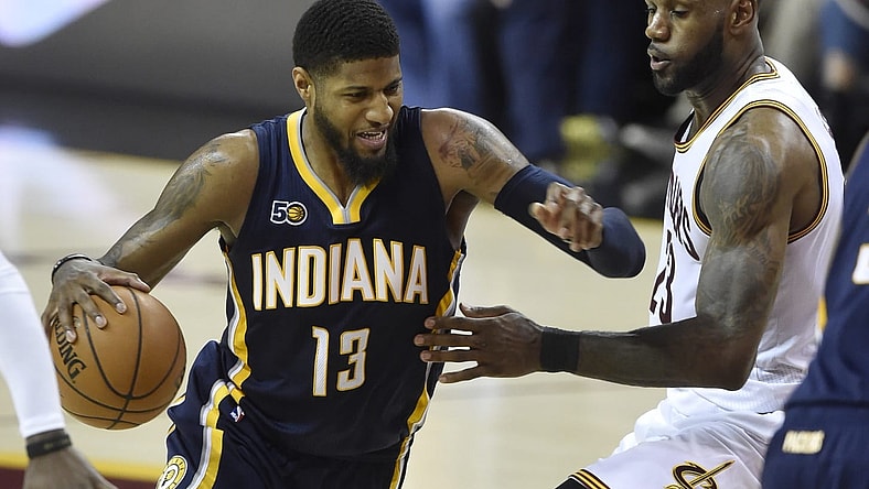Paul George drives on LeBron James