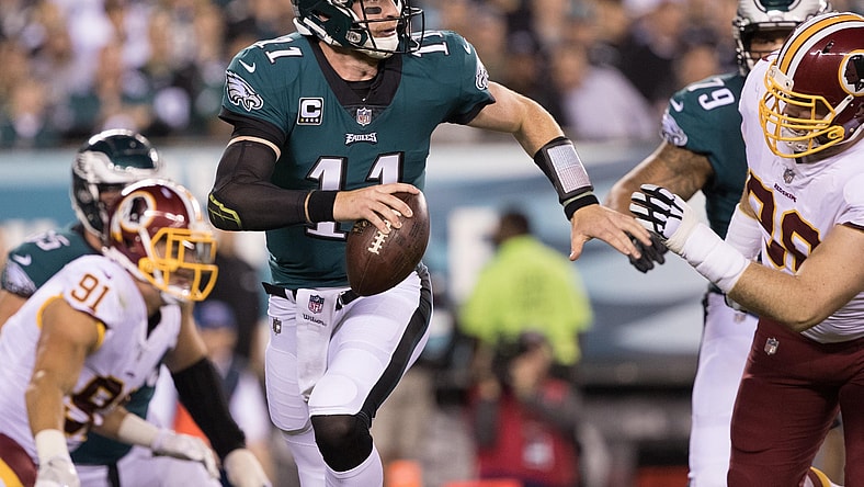 NFL Philadelphia Eagles quarterback Carson Wentz (11) runs out of the pocket past Washington Redskins defensive tackle Matthew Ioannidis (98) during the first quarter at Lincoln Financial Field.