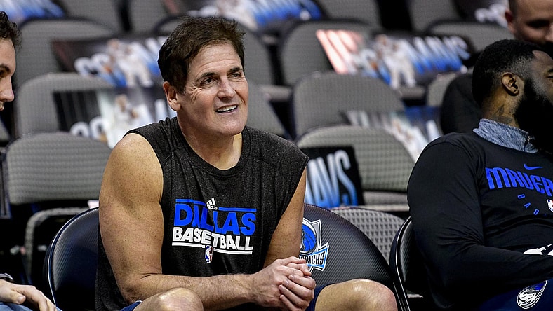 Dallas Mavericks owner Mark Cuban sits on the bench