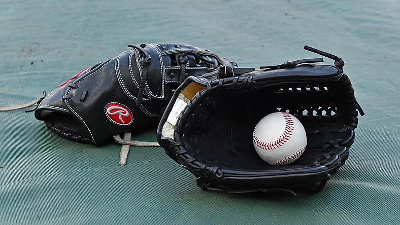 Gloves and baseball at MLB stadiun