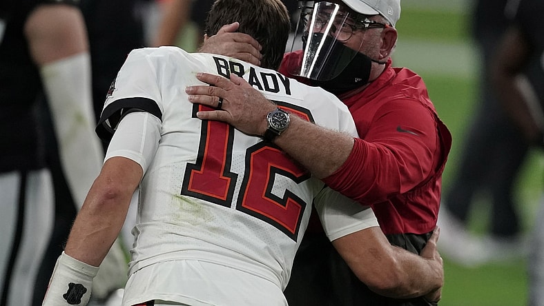 Oct 25, 2020; Paradise, Nevada, USA; Tampa Bay Buccaneers quarterback Tom Brady (12) and coach Bruce Arians embrace after the game against the Las Vegas Raiders at Allegiant Stadium. The Buccaneers defeated the Raiders 45-20. Mandatory Credit: Kirby Lee-USA TODAY Sports