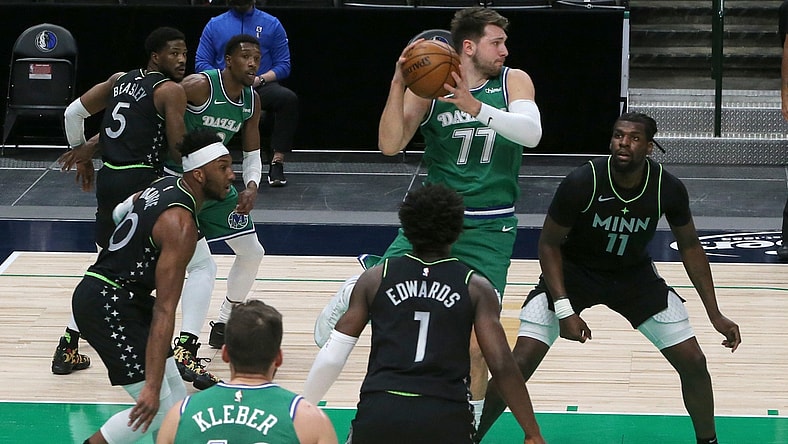 Feb 8, 2021; Dallas, Texas, USA; Dallas Mavericks guard Luka Doncic (77) looks to pass as Minnesota Timberwolves center Naz Reid (11) defends during the first half at American Airlines Center. Mandatory Credit: Kevin Jairaj-USA TODAY Sports