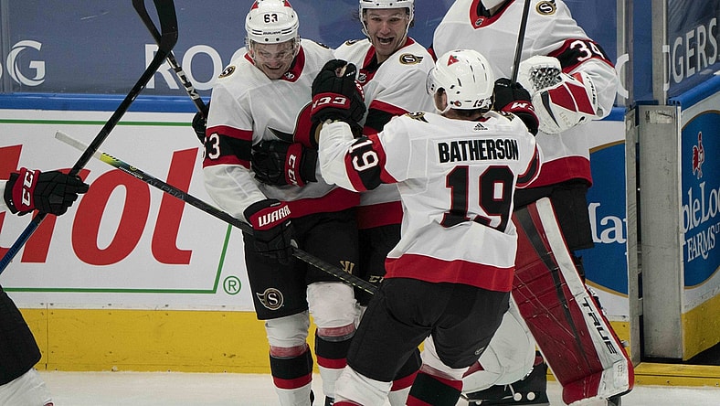 Feb 15, 2021; Toronto, Ontario, CAN; Ottawa Senators right wing Evgenii Dadonov (63) celebrates with center Josh Norris (9) after scoring a goal against the Toronto Maple Leafs during the overtime period at Scotiabank Arena. Mandatory Credit: Nick Turchiaro-USA TODAY Sports