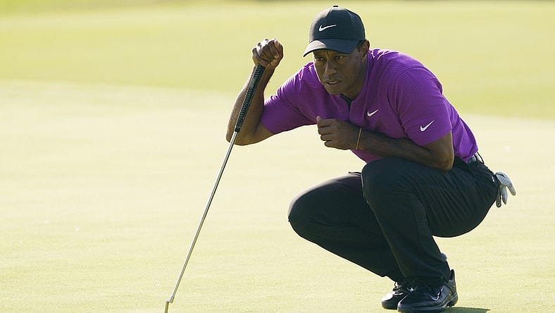 Nov 14, 2020; Augusta, Georgia, USA; Tiger Woods lines up his putt on the 17th green during the third round of The Masters golf tournament at Augusta National GC. Mandatory Credit: Michael Madrid-USA TODAY Sports