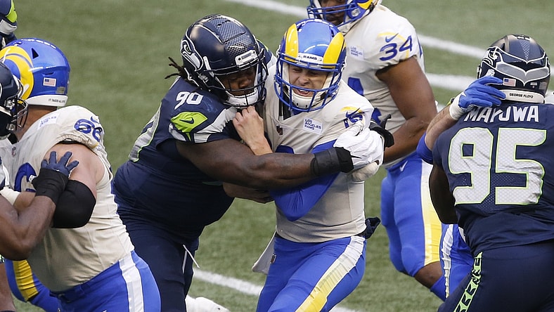 Jan 9, 2021; Seattle, Washington, USA; Seattle Seahawks defensive tackle Jarran Reed (90) sacks Los Angeles Rams quarterback Jared Goff (16) during the third quarter at Lumen Field. Mandatory Credit: Joe Nicholson-USA TODAY Sports