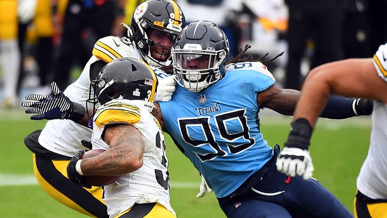 Oct 25, 2020; Nashville, Tennessee, USA; Tennessee Titans outside linebacker Jadeveon Clowney (99) tackles Pittsburgh Steelers running back James Conner (30) at Nissan Stadium. Mandatory Credit: Christopher Hanewinckel-USA TODAY Sports