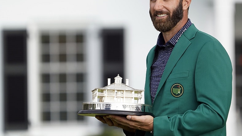 Nov 15, 2020; Augusta, Georgia, USA; Dustin Johnson celebrates with the Masters Trophy after winning The Masters golf tournament at Augusta National GC. Michael Madrid-USA TODAY Sports