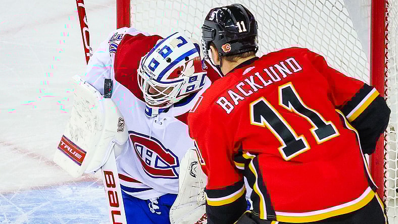 Apr 23, 2021; Calgary, Alberta, CAN; Montreal Canadiens goaltender Jake Allen (34) makes a save against the Calgary Flames during the second period at Scotiabank Saddledome. Mandatory Credit: Sergei Belski-USA TODAY Sports