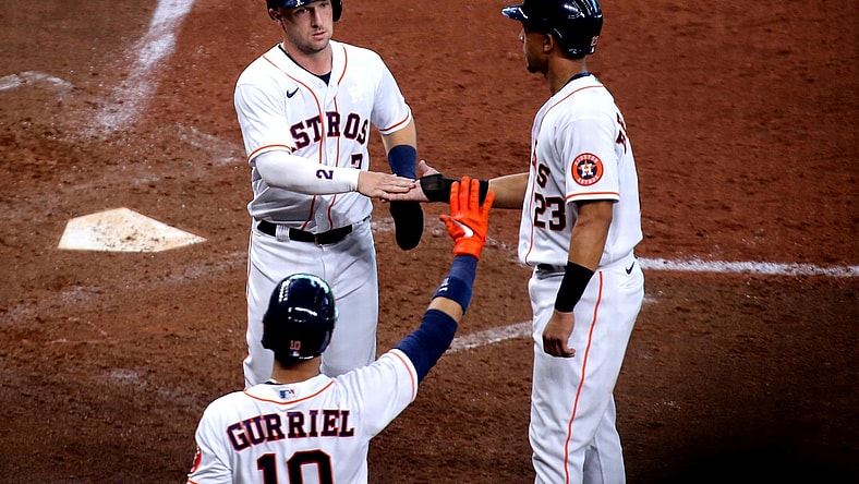 Apr 24, 2021; Houston, Texas, USA; Houston Astros third baseman Alex Bregman (2, left) is congratulated by left fielder Michael Brantley (23) after scoring a run against the Los Angeles Angels during the fifth inning at Minute Maid Park. Mandatory Credit: Erik Williams-USA TODAY Sports
