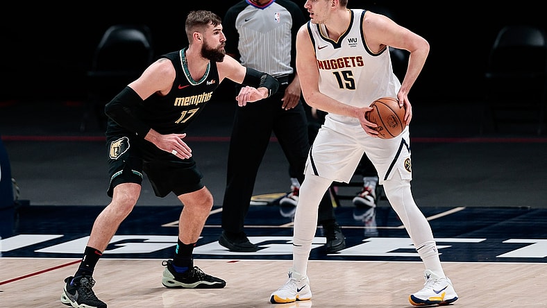 Apr 26, 2021; Denver, Colorado, USA; Denver Nuggets center Nikola Jokic (15) controls the ball as Memphis Grizzlies center Jonas Valanciunas (17) guards in the first quarter at Ball Arena. Mandatory Credit: Isaiah J. Downing-USA TODAY Sports