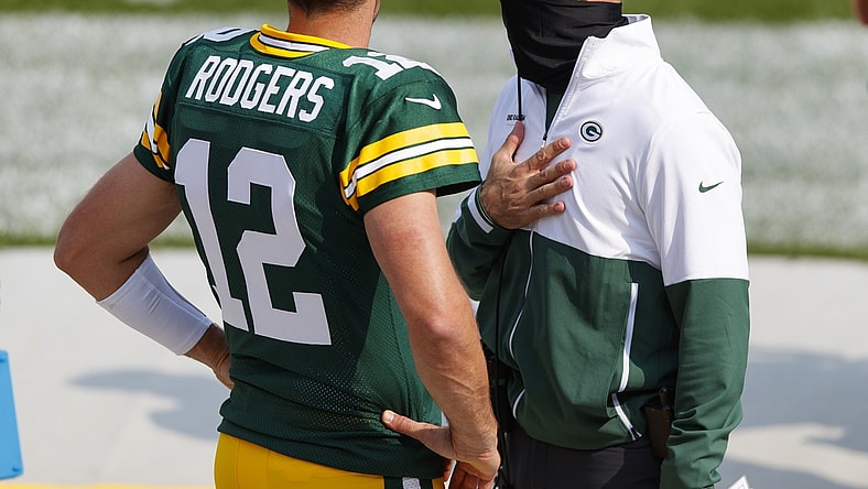 Sep 20, 2020; Green Bay, Wisconsin, USA;  Green Bay Packers quarterback Aaron Rodgers (12) talks with head coach Matt LaFleur during the third quarter of the game against the Detroit Lions at Lambeau Field. Mandatory Credit: Jeff Hanisch-USA TODAY Sports