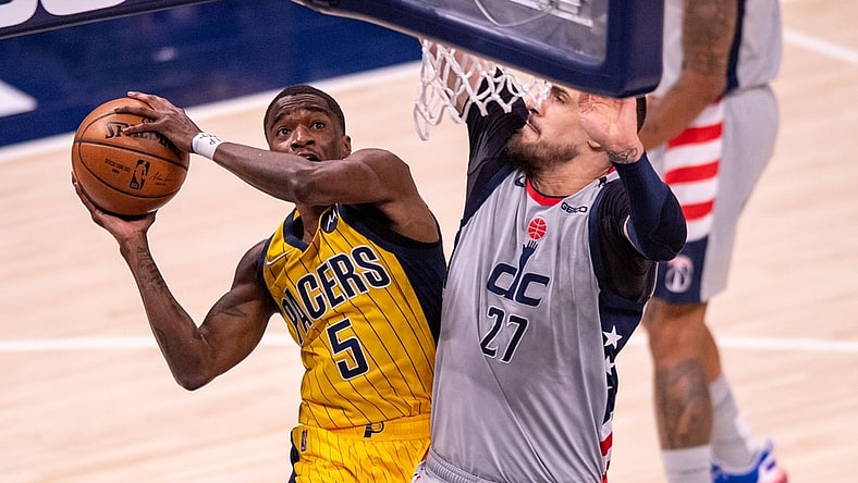 May 8, 2021; Indianapolis, Indiana, USA; Indiana Pacers guard Edmond Sumner (5) shoots against Washington Wizards center Alex Len (27) during the first half of an NBA basketball game at Bankers Life Fieldhouse. Mandatory Credit: Doug McSchooler-USA TODAY Sports