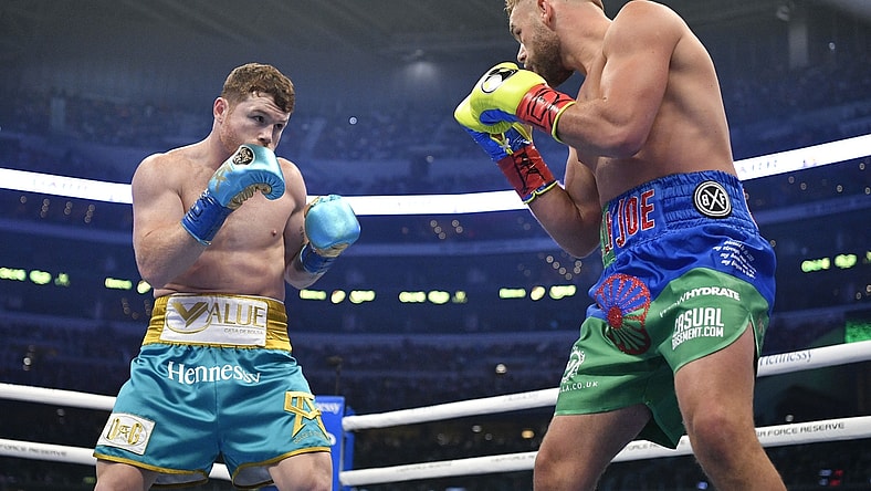 May 8, 2021; Arlington, Texas, USA; Canelo Alvarez (teal trunks) and Billy Joe Saunders (blue green trunks) during a super middleweight boxing title fight at AT&T Stadium. Mandatory Credit: Jerome Miron-USA TODAY Sports