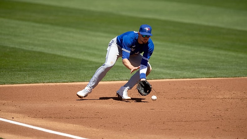 May 6, 2021; Oakland, California, USA; Toronto Blue Jays third baseman Cavan Biggio fields a ground ball by Oakland Athletics right fielder Stephen Piscotty during the second inning at RingCentral Coliseum. Mandatory Credit: D. Ross Cameron-USA TODAY Sports
