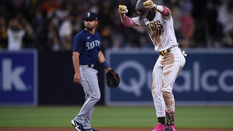 May 22, 2021; San Diego, California, USA; San Diego Padres shortstop Fernando Tatis Jr. (right) reacts on second base after hitting a double during the seventh inning as Seattle Mariners second baseman Jack Mayfield (left) looks on at Petco Park. Mandatory Credit: Orlando Ramirez-USA TODAY Sports