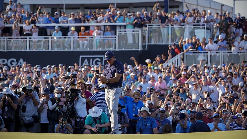 May 23, 2021; Kiawah Island, South Carolina, USA; Phil Mickelson checks his notes before putting on the 18th green during the final round of the PGA Championship golf tournament. Mandatory Credit: Geoff Burke-USA TODAY Sports