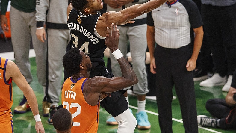 Jul 20, 2021; Milwaukee, Wisconsin, USA; Milwaukee Bucks forward Giannis Antetokounmpo (34) shoots over Phoenix Suns center Deandre Ayton (22) during the third quarter during game six of the 2021 NBA Finals at Fiserv Forum. Mandatory Credit: Jeff Hanisch-USA TODAY Sports