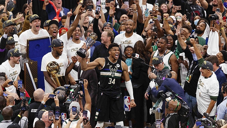 Jul 20, 2021; Milwaukee, Wisconsin, USA; Milwaukee Bucks forward Giannis Antetokounmpo (34) celebrates with the NBA Finals MVP Trophy following the game against the Phoenix Suns following game six of the 2021 NBA Finals at Fiserv Forum. Mandatory Credit: Jeff Hanisch-USA TODAY Sports