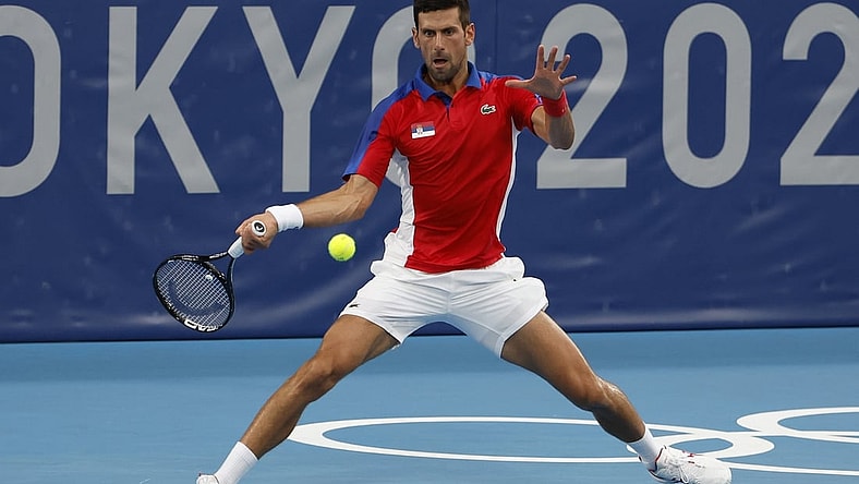 Jul 26, 2021; Tokyo, Japan; Novak Djokovic of Serbia hits a forehand against Jan-Lennard Struff of Germany (not pictured) in a second round mens' singles match during the Tokyo 2020 Olympic Summer Games at Ariake Tennis Park. Mandatory Credit: Geoff Burke-USA TODAY Sports