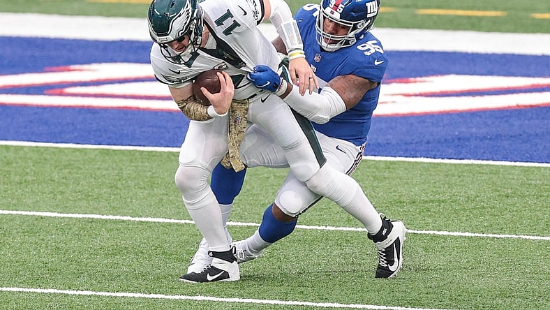 Nov 15, 2020; East Rutherford, New Jersey, USA; Philadelphia Eagles quarterback Carson Wentz (11) is sacked by New York Giants defensive tackle B.J. Hill (95) during the first half at MetLife Stadium. Mandatory Credit: Vincent Carchietta-USA TODAY Sports