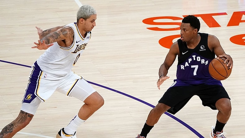May 2, 2021; Los Angeles, California, USA; Toronto Raptors guard Kyle Lowry (7) controls the ball against Los Angeles Lakers forward Kyle Kuzma (0) during the second half at Staples Center. Mandatory Credit: Gary A. Vasquez-USA TODAY Sports