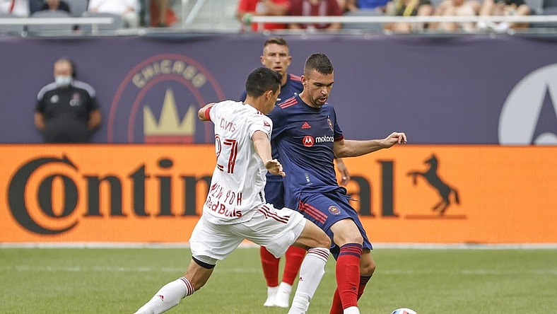 Aug 8, 2021; Chicago, Illinois, USA; Chicago Fire midfielder Luka Stojanovic (8) is defended by New York Red Bulls midfielder Sean Davis (27) during the first half of a MLS game at Soldier Field. Mandatory Credit: Kamil Krzaczynski-USA TODAY Sports