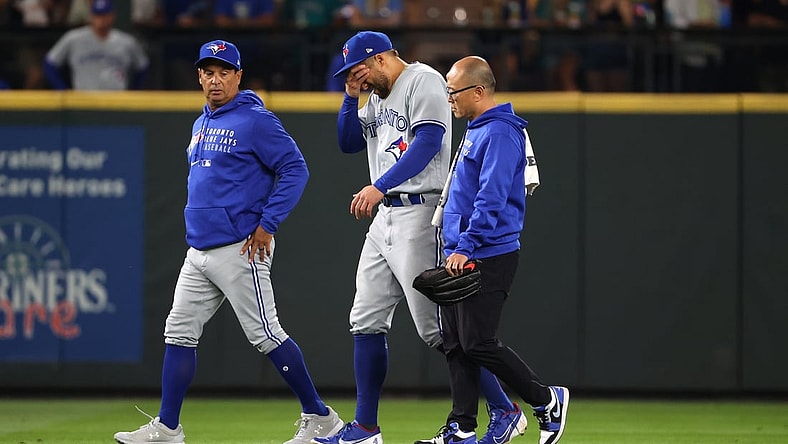 Aug 14, 2021; Seattle, Washington, USA; Toronto Blue Jays center fielder George Springer (4) reacts while exiting the game after suffering an apparent injury to his lower leg while attempting to make a plain a ball hit for a triple by Seattle Mariners first baseman Ty France (not pictured) during the seventh inning at T-Mobile Park. Mandatory Credit: Abbie Parr-USA TODAY Sports