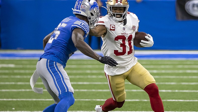 Sep 12, 2021; Detroit, Michigan, USA; San Francisco 49ers running back Raheem Mostert (31) puts a stiff arm to the helmet of Detroit Lions defensive back Will Harris (25) in the first quarter at Ford Field. Mandatory Credit: David Reginek-USA TODAY Sports