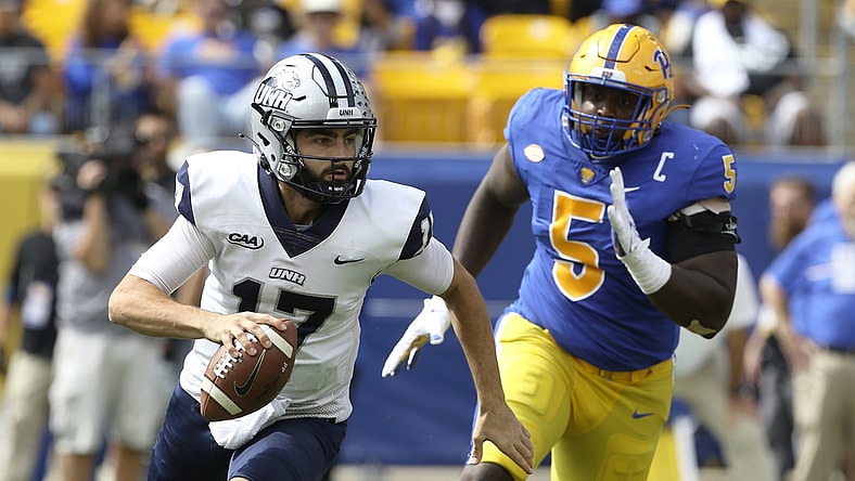 Sep 25, 2021; Pittsburgh, Pennsylvania, USA;  New Hampshire Wildcats quarterback Bret Edwards (17) scrambles with the ball as Pittsburgh Panthers defensive lineman Deslin Alexandre (5) chases during the second quarter at Heinz Field. Mandatory Credit: Charles LeClaire-USA TODAY Sports