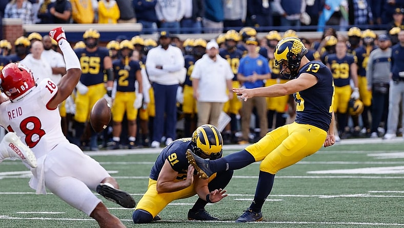 Sep 25, 2021; Ann Arbor, Michigan, USA;  Michigan Wolverines place kicker Jake Moody (13) kicks a field goal out of the hold by Michigan Wolverines punter Brad Robbins (91) in first half against the Rutgers Scarlet Knights at Michigan Stadium. Mandatory Credit: Rick Osentoski-USA TODAY Sports