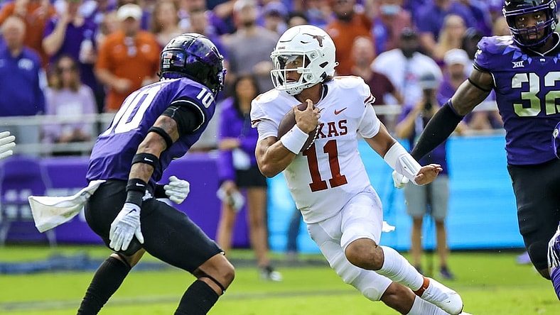 Oct 2, 2021; Fort Worth, Texas, USA; Texas Longhorns quarterback Casey Thompson (11) runs with the ball as TCU Horned Frogs safety Da'Veawn Armstead (10) defends during the first quarter at Amon G. Carter Stadium. Mandatory Credit: Kevin Jairaj-USA TODAY Sports
