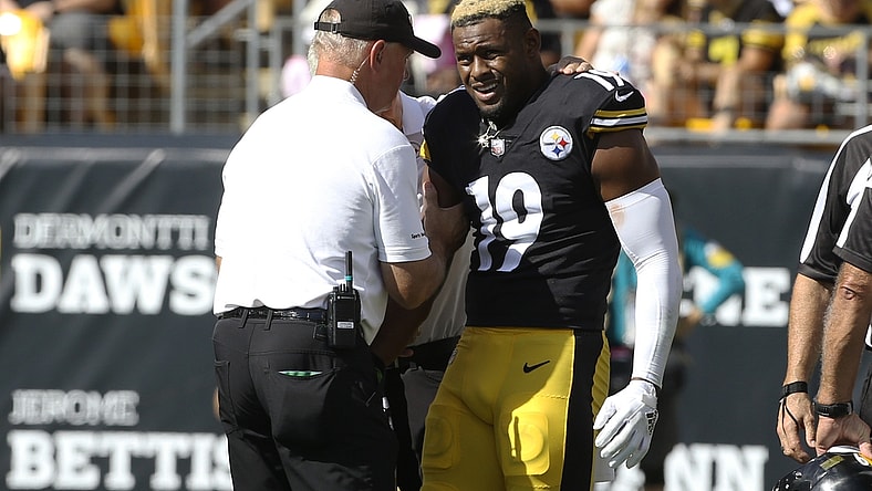 Oct 10, 2021; Pittsburgh, Pennsylvania, USA; Pittsburgh Steelers team orthopedic doctor James Bradley (left) looks at the right arm of Pittsburgh Steelers wide receiver JuJu Smith-Schuster (19) after Smith-Schuster suffered an apparent injury against the Denver Broncos during the second quarter at Heinz Field. Smith-Schuster would leave the game. Mandatory Credit: Charles LeClaire-USA TODAY Sports