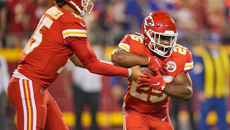 Oct 10, 2021; Kansas City, Missouri, USA; Kansas City Chiefs quarterback Patrick Mahomes (15) hands off to running back Clyde Edwards-Helaire (25) during the first half against the Buffalo Bills at GEHA Field at Arrowhead Stadium. Mandatory Credit: Jay Biggerstaff-USA TODAY Sports