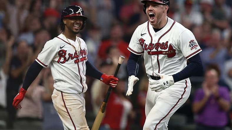 Oct 12, 2021; Cumberland, Georgia, USA; Atlanta Braves first baseman Freddie Freeman (right) celebrates with  second baseman Ozzie Albies (left) after hitting a home run against the Milwaukee Brewers during the eighth inning in game four of the 2021 ALDS at Truist Park. Mandatory Credit: Brett Davis-USA TODAY Sports